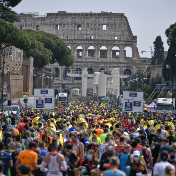 Marathon runners in Rome with monument in background