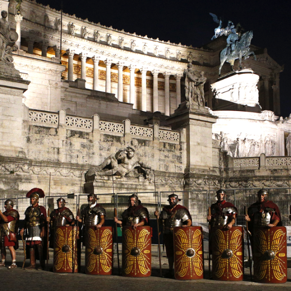 Marathon runners in Rome passing ancient architecture