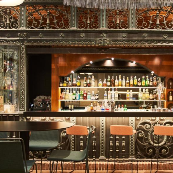 Decorative bar area inside the Silken Ramblas Hotel in Barcelona, featuring ornate ironwork and a fully stocked bar.
